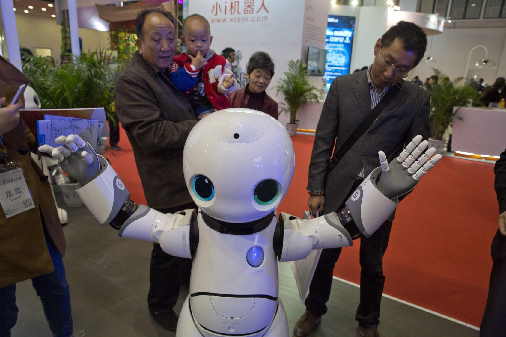 Visitors look at the Canbot companion robot during the World Robot Conference in Beijing, China, Friday, Oct. 21, 2016. The conference showcased China's burgeoning robot industry as the nation seeks to increase the use of robots in its manufacturing and service industries. (AP Photo/Ng Han Guan)